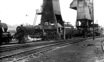 Ex LMS 45342, 45017, and BR Standard 73069 (75069?) are amongst other Steam locomotives close to the "Ash Plant" and the "Coaling Tower" at Carnforth locomotive Motive Power Depot. Although undated, the cleaned / highlighted smokebox number plates suggests that this was close to 1968. Cumbrian Railway Association Bowtell Collection.