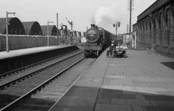 Circa 1955. Ex LMS Class 2P 4-4-0 No. 40557 pilots unidentified BR "Britannia" class 4-6-2 with an express passenger train from the north. Cumbrian Railways Association Worden collection.