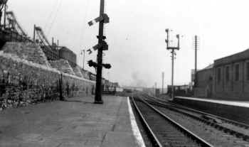 1922 View north along down main platforms at Carnforth. The furnaces in the Carnforth Ironworks can be seen on the left. Cumbrian Railway Association Bowtell Collection.