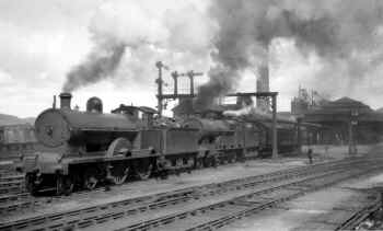 August 1928. Ex-LNWR "George V" Class LMS No. 5296 "Dreadnought" pilots inidentified ex-LNWR 4-6-0 "Claughton" Class away from Carnforth with the up "Royal Scot" after changing engines at Carnforth. Harold Bowtell.