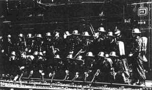 "Storm troopers" pose next to a steam engine.