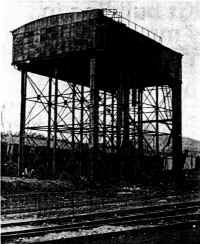 The water-tank, Miniature ralway tracks are behind the fence.